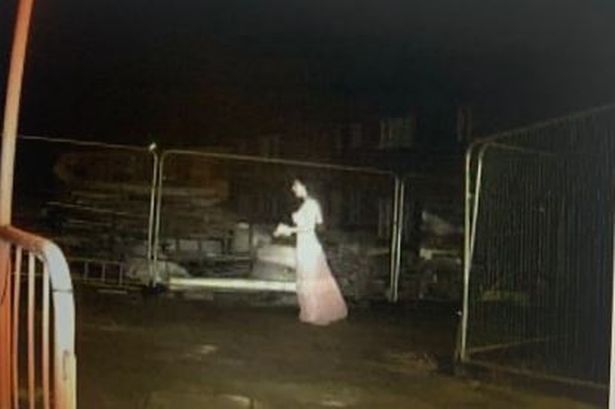 The creepy lady in white at a construction site